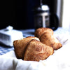 Four freshly baked vegan Ciabatta bread on a table with a chequered table cloth