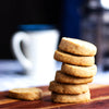 A stack of eggless Classic Butter Cookies on a wooden surface