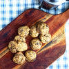 A pack of eggless mini chocolate chip cookies on a wooden board