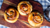 3 soft cinnamon rolls on a wooden platter