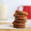 Stack of gluten free butter cookies on a wooden surface with a blurred background