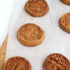 Freshly baked gluten free butter cookies on a baking sheet with parchment paper