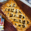 A classic winter apple pie on a wooden surface