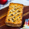 A classic winter apple pie on a wooden surface