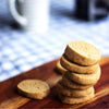 A stack of eggless Classic Butter Cookies on a wooden surface