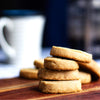 A stack of eggless Classic Butter Cookies on a wooden surface