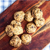 A pack of eggless mini chocolate chip cookies on a wooden board
