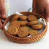 Wicker basket with Jaggery Butter cookies on a white surface