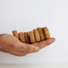Hand holding freshly baked Jaggery Butter cookies with a white background
