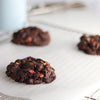 Freshly baked NYC Chocolate Almond Praline cookies on a cooling rack